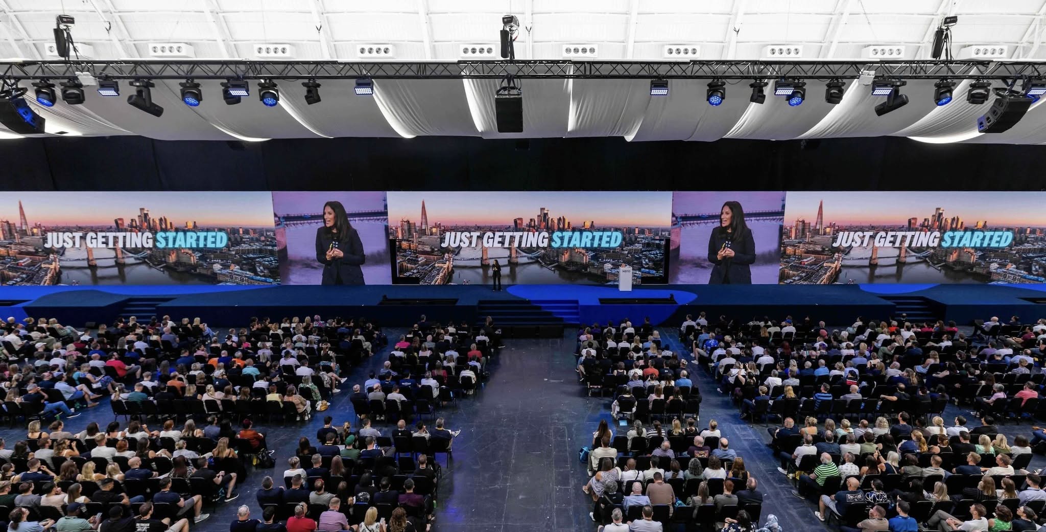 Wide view of the Xerocon main stage, featuring a 69 metre LED display showing keynote content to a large seated audience.
