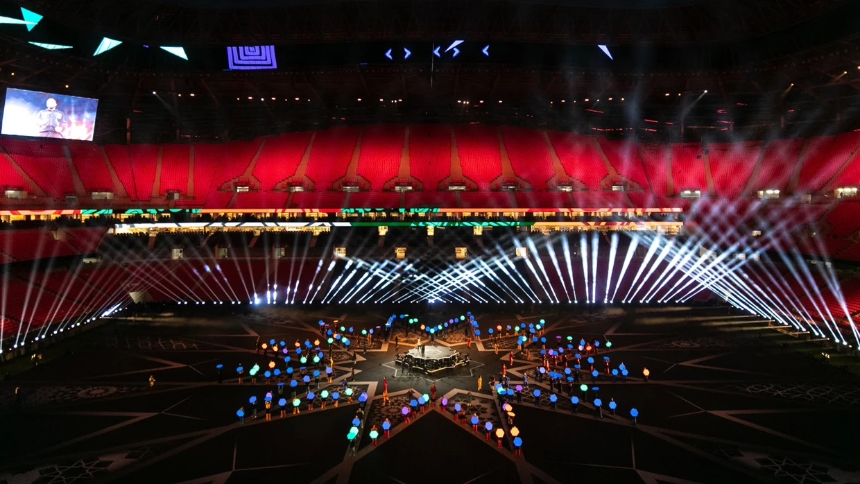 An overview image taking at the TotalEnergies CAF Africa Cup of Nations 2025 Opening Ceremony at Prince Moulay Abdellah Stadium in Rabat, Morocco. On the field multiple dancers are holding Hex Panels a technical solution designed and engineered by PRG Projects. The dancers are holding the hex shaped portable LED screens to shape an outline of a 12 pointed star. The screens are displaying different colors.