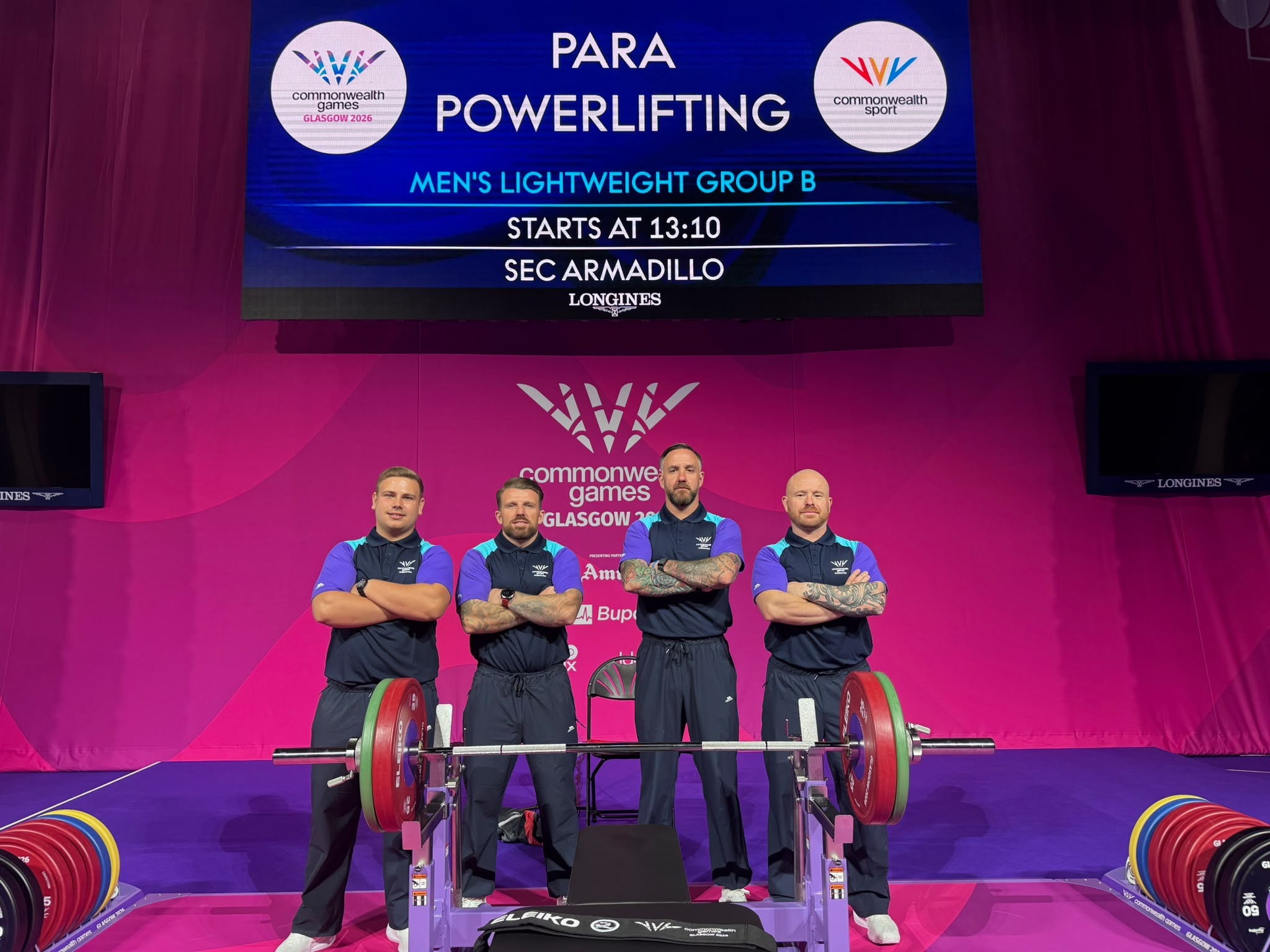 Luke Johnson with fellow spotters and loaders on the Para Powerlifting stage at the Glasgow 2026 Commonwealth Games.
