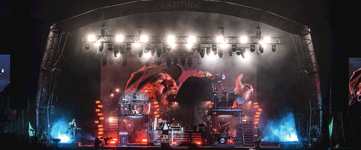 Teddy Swims performs with his band on the main stage at Latitude Festival, surrounded by a house-inspired set, large LED screens and red, blue and white lighting.